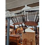 A pair of mid 20th century teak and black spindle back armchairs/carvers.