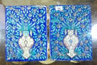A pair of Qajar tin glazed panels, late 19th century, 22cm x 28cm, removed from a large manor