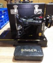 A Singer Featherweight electric travel sewing machine with case.