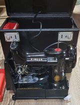 A Singer 222K Featherweight sewing machine, cased with accessories including button holer, various