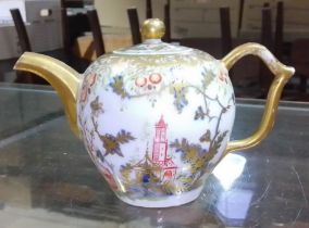 A Meissen 18th century bullet shaped teapot with wishbone handle, chinoiserie decoration crossed