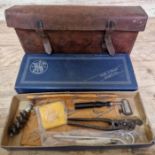 A WWII leather satchel containg a Smith & Western box of bullet making equipment to include a