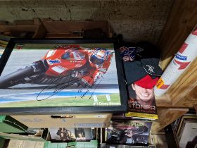 A group of Casey Stoner motorcycle racer memorabilia to include signed pictures (one glazed &