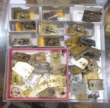 A box of French clock platform escapements and parts.