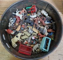 A tin of assorted farm animal toys to include cast metal & plastic.