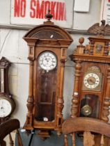 A walnut cased three weight Vienna wall clock, complete with weights, pendulum and key.