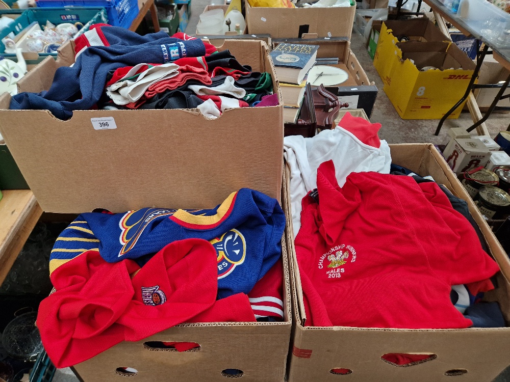 Three boxes of assorted rugby, cricket and other sporting jerseys.