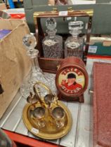 A mixed lot comprising tantalus and two decanters, ship's decanter, Tetley bitter light up sign