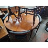 A mid 20th century G Plan teak extending dining table and four chairs.