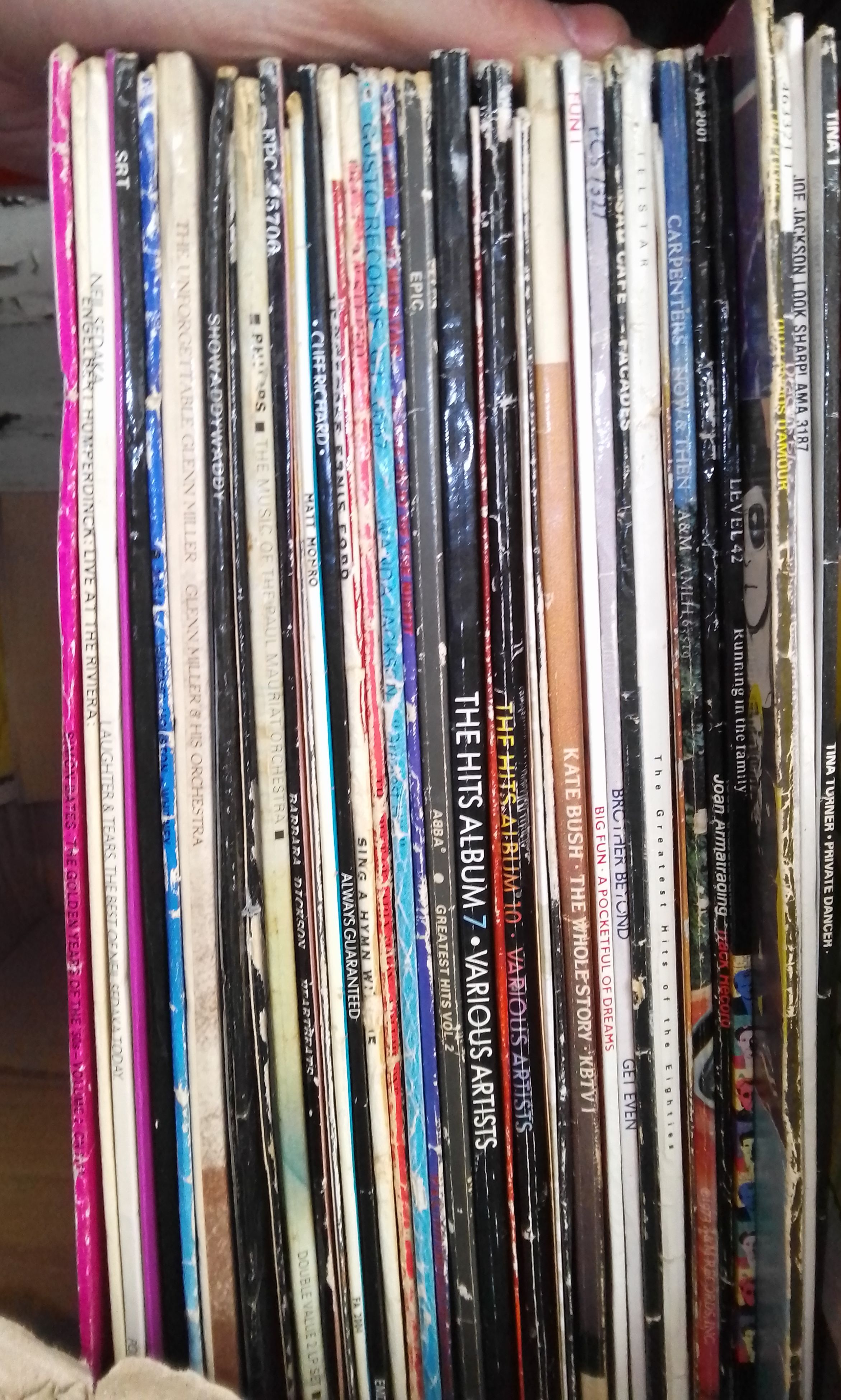 A box of vinyl LP records, rock and pop including Tina Turner, Deacon Blue, The Police, etc.