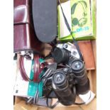 A box of cameras including Zenit, Olympia, binoculars, Acer tablet, headphones, Bolex cine camera