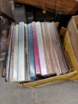 A box of assorted LPs.