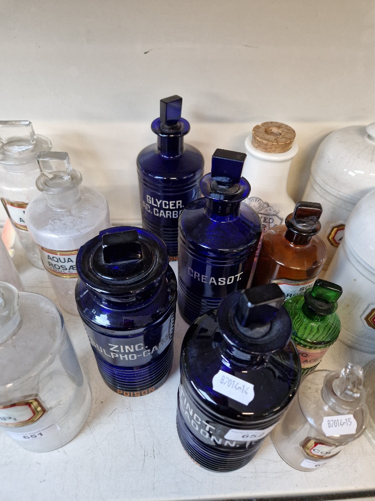 A group of four blue apothecary bottles