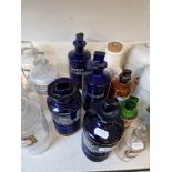 A group of four blue apothecary bottles