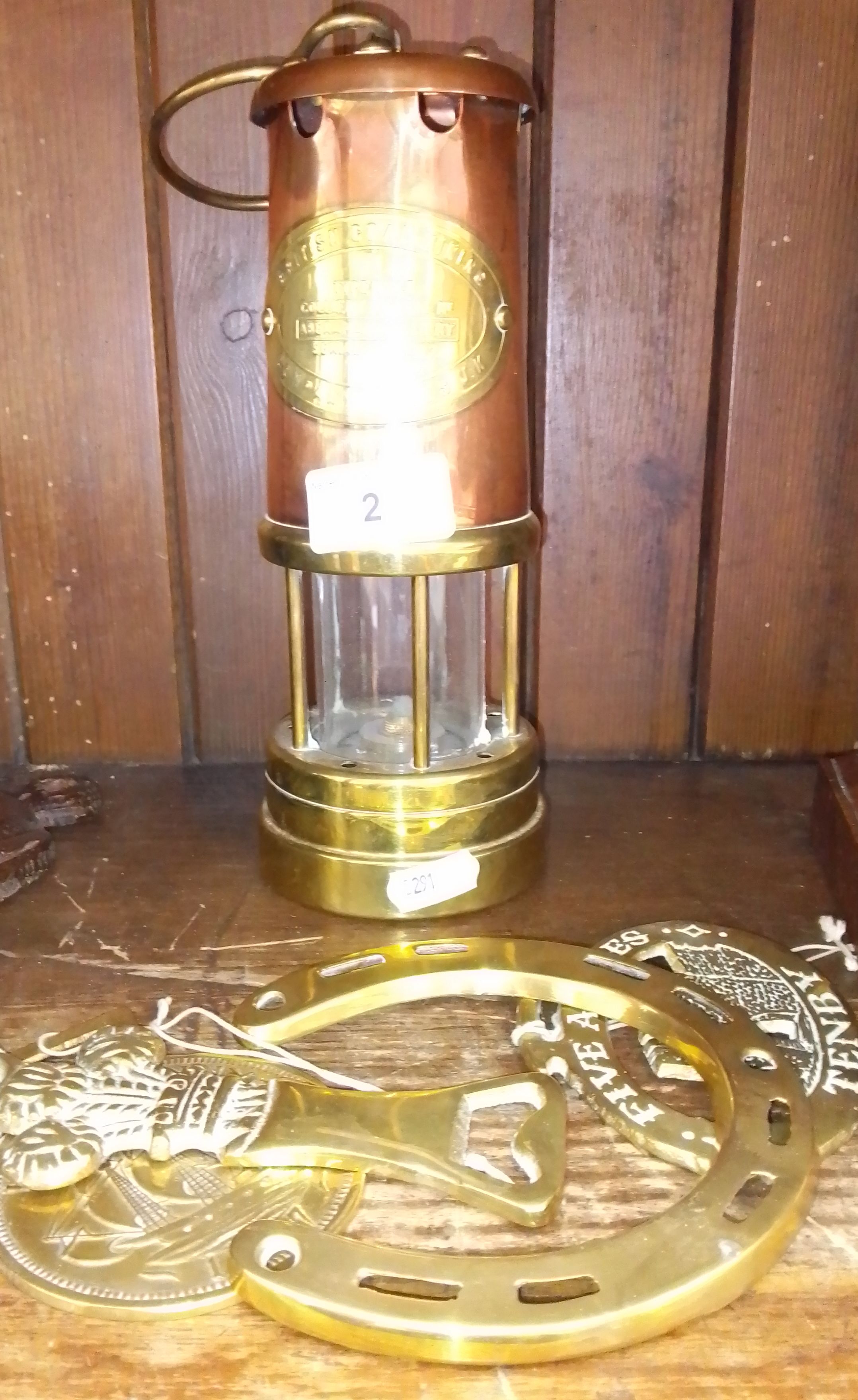 A repro miners lamp together with horse brasses
