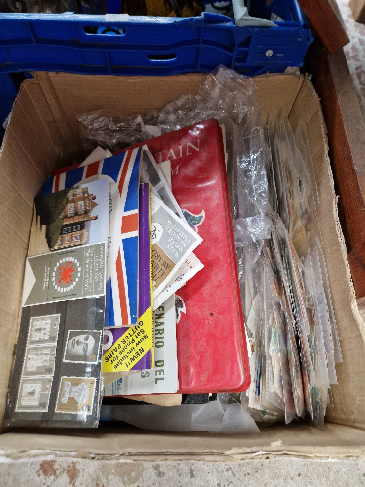A box of assorted stamp albums, loose stamps and covers.