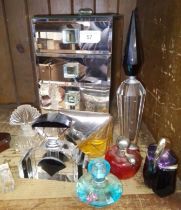 A glass jewellery box and a group of perfume bottles