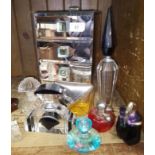 A glass jewellery box and a group of perfume bottles