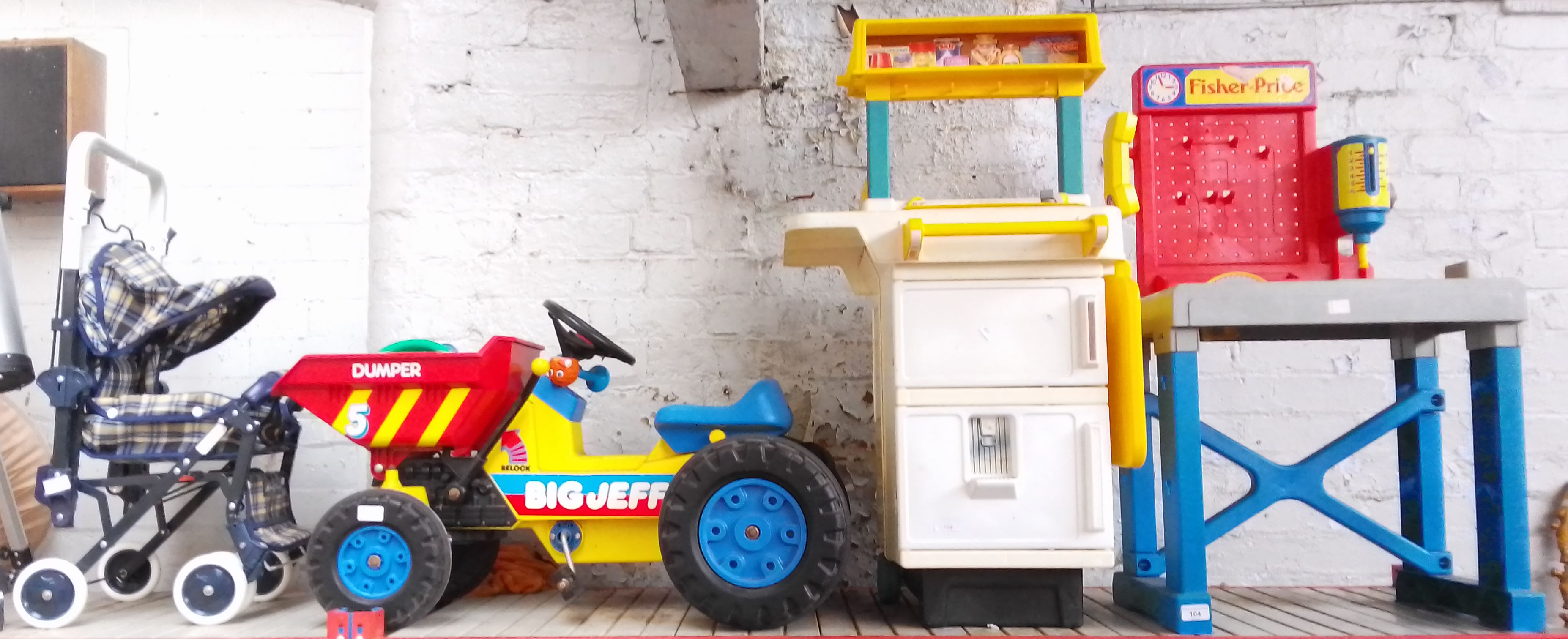 Three large toys - workbench, cooker/fridge, and a Big Jeff Dumper, Also includes child's pram