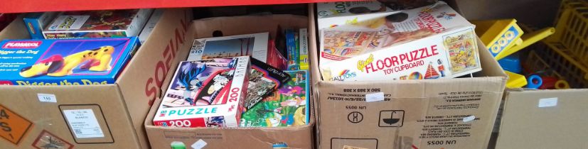 4 boxes of toys and games to include jigsaws, Floor puzzles, Playskool Digger the Dog, plastic