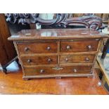 A Victorian mahogany and oak miniature chest of drawers.