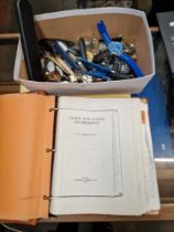 A box of watches together with a manual on clocks and watch movements