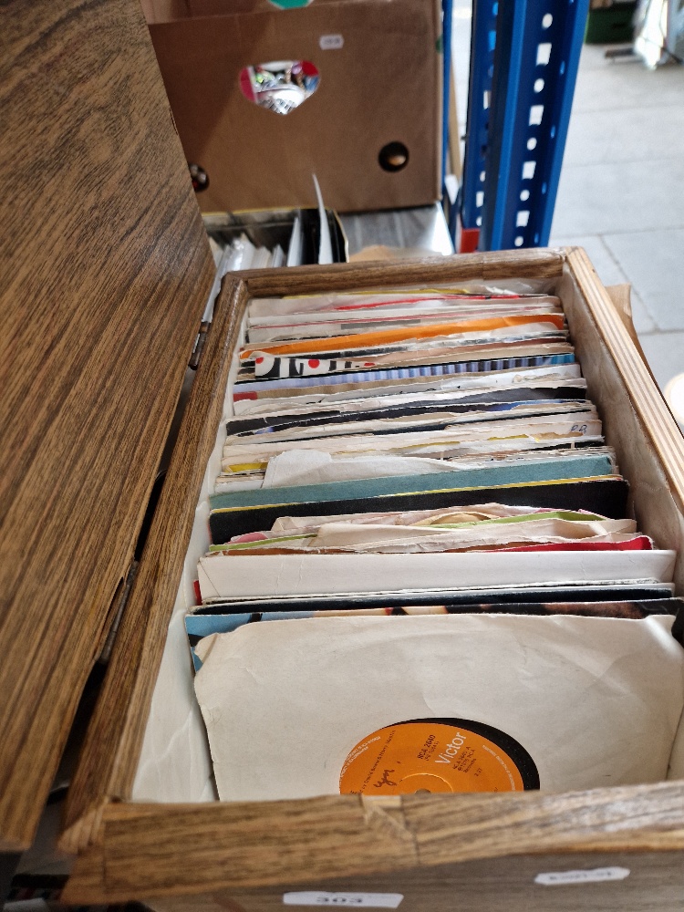 A box of 7" vinyl rock singles including Bob Dylan, U2, Bowie, Queen, Paul McCartney, Genesis, etc.