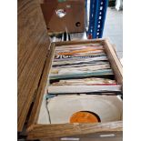 A box of 7" vinyl rock singles including Bob Dylan, U2, Bowie, Queen, Paul McCartney, Genesis, etc.