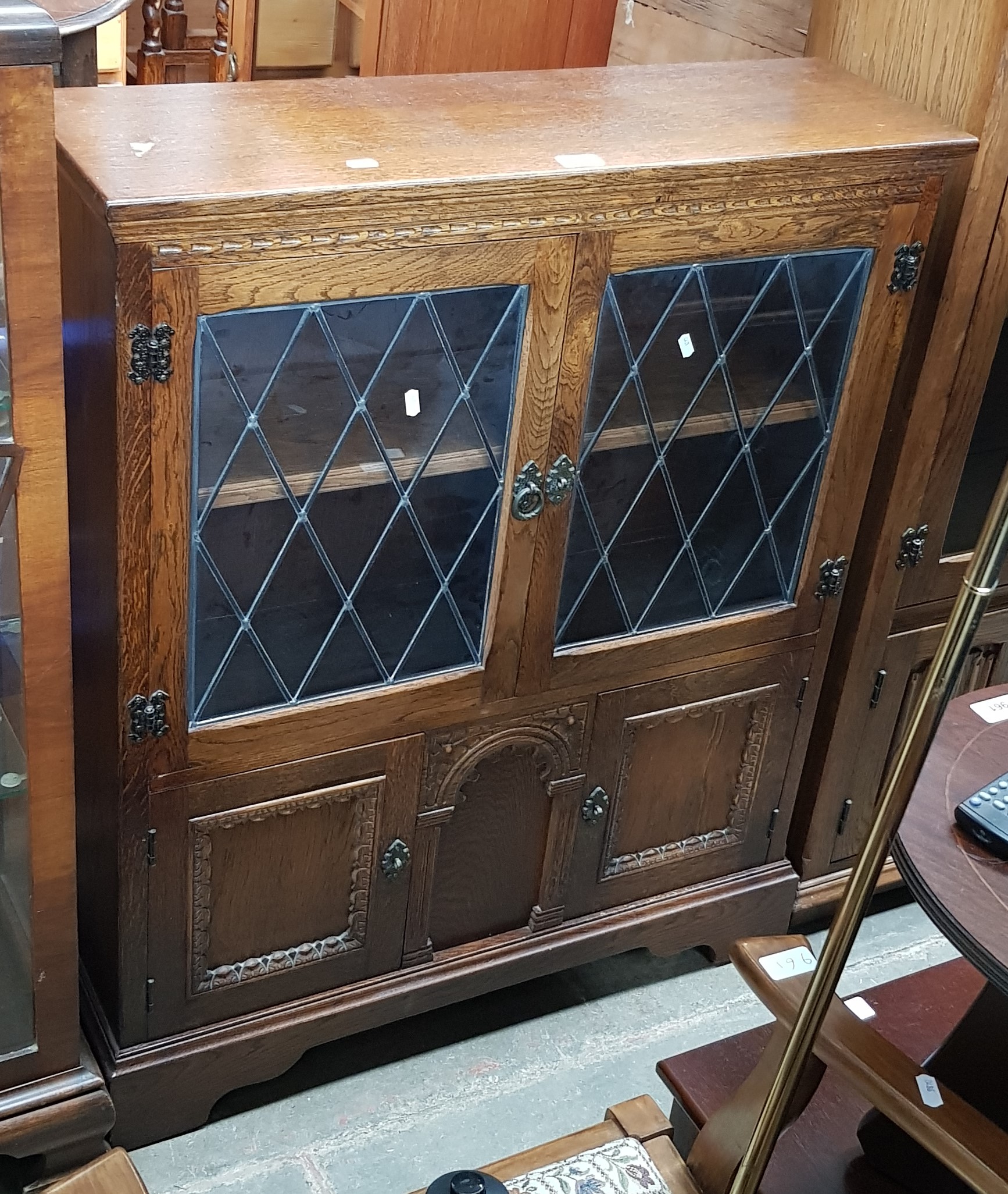 An oak bookcase with leaded glass doors.
