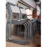 A group of 10 stackable tubular metal & canvas chairs.