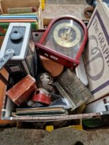 A box of assorted collectables including a camera, a pair of binoculars, a clock, a cast metal money
