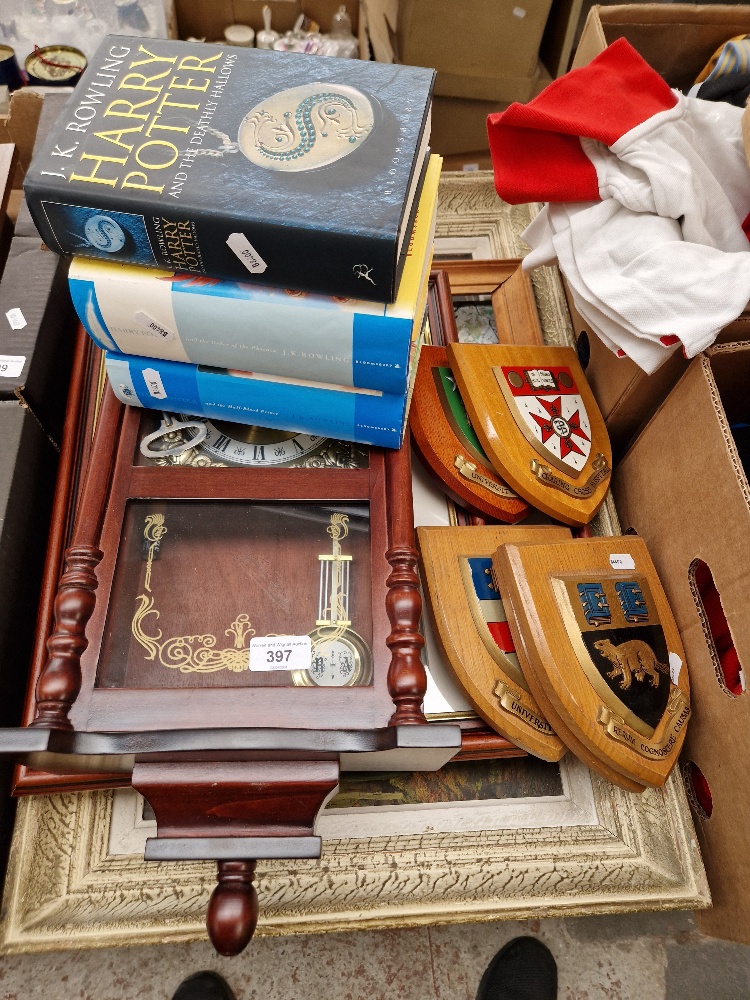 A mixed lot including original pictures, a clock, Harry Potter books and shields.