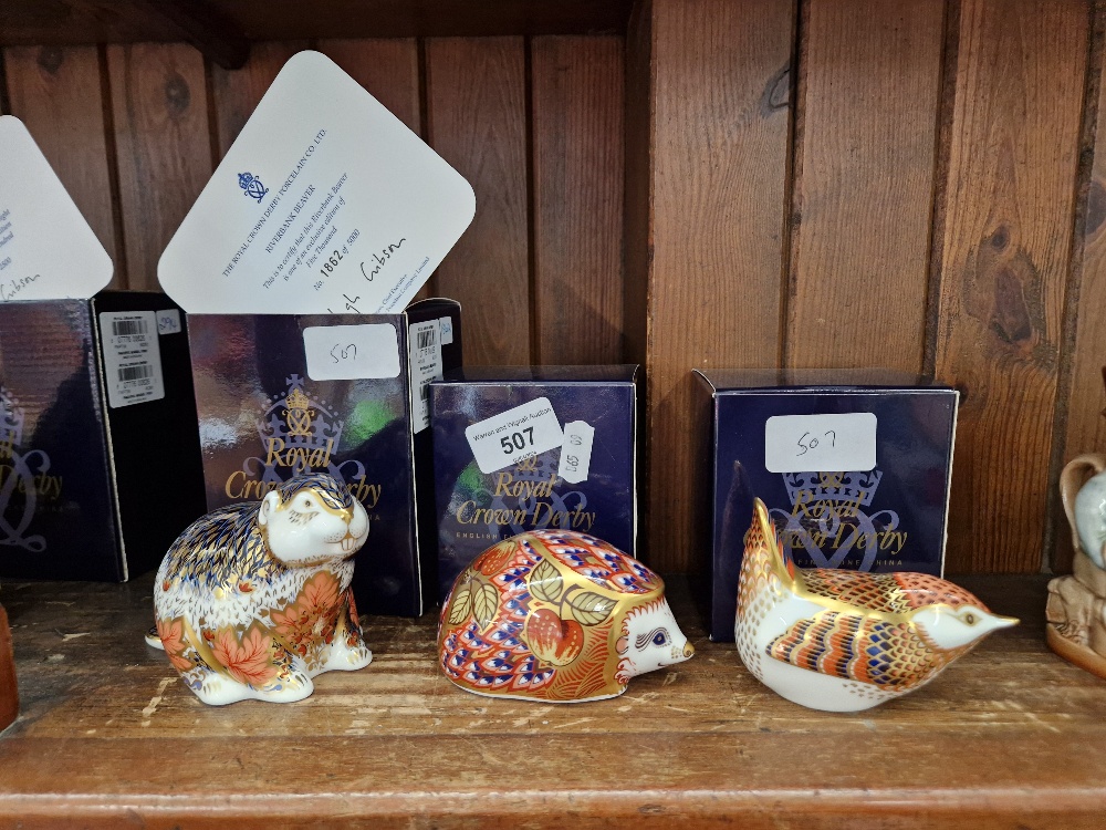 Three Royal Crown Derby paperweights including limited edition Riverbank Beaver 1862/5000, with gold