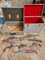 A collection of ornamental flintlock replicas and two flight cases.