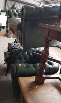 A green leather Chesterfield suite comprising three seater sofa, club chair, wingback armchair and