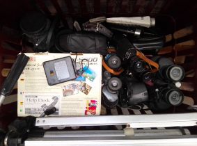 A box of binoculars, tripods, cameras and lenses