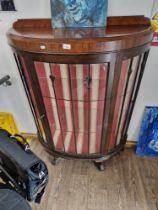 An early 20th century mahogany bow front display cabinet on ball and claw feet.