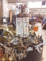 A large chandelier with glass droplets and 2 matching smaller ones