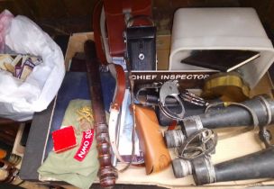 A box of collectables including binoculars, police truncheon, sun glasses, badges, police handcuffs,