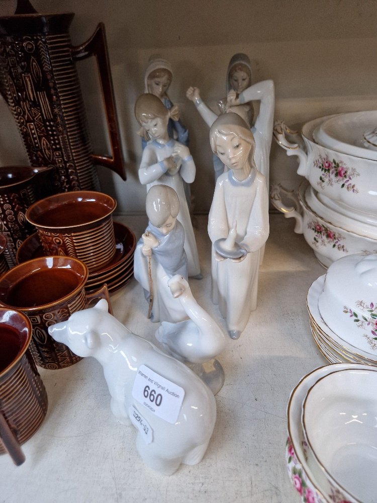 Eight Lladro figurines including girl with posy, polar bear, goose, girl with candlestick, seated