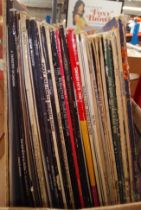 A box of vinyl LP records, rock and pop including Santana, Abba, R Dean Taylor, etc.