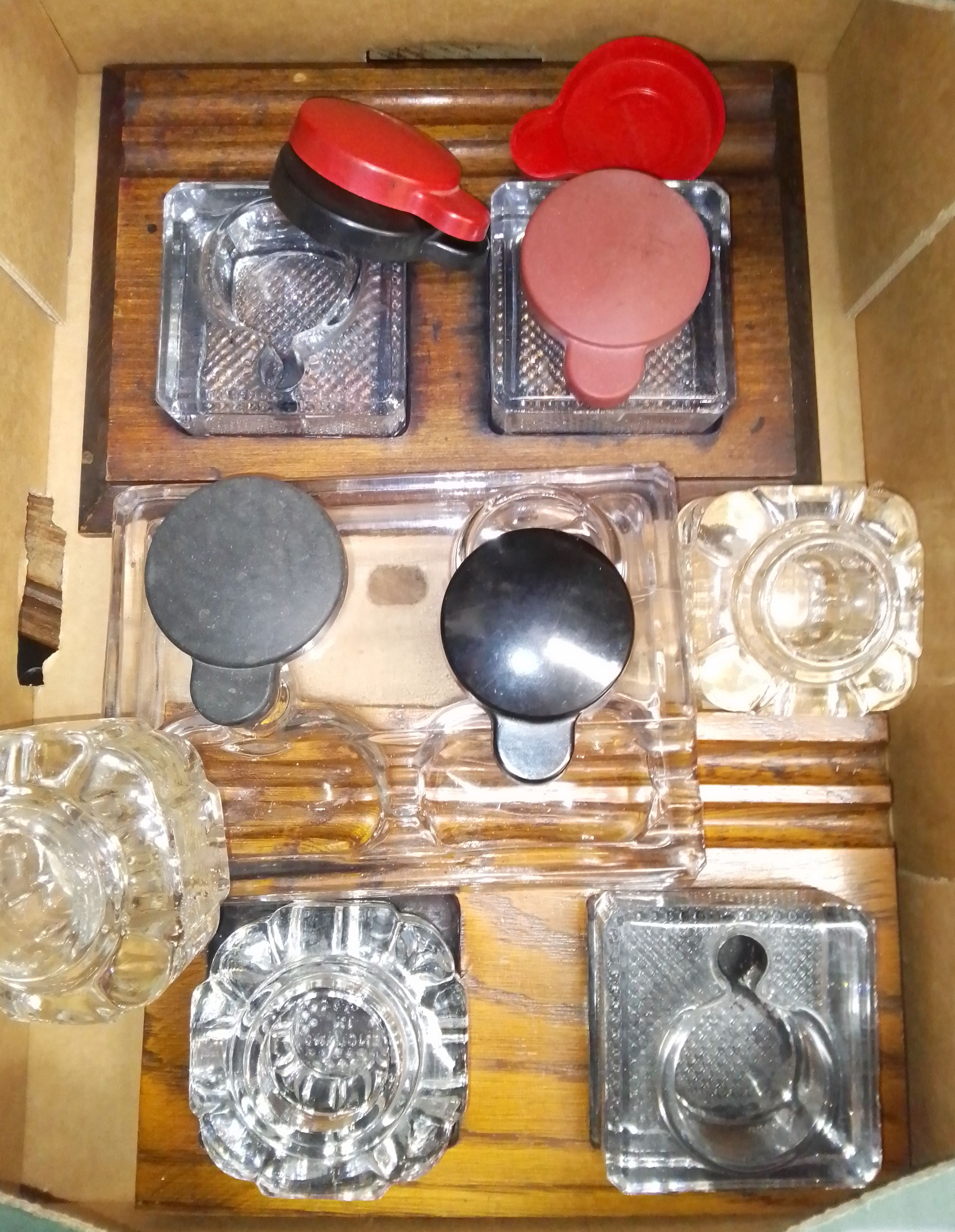 A box of glass inkwells, some with wooden bases