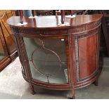 An early 20th century mahogany demi-lune display cabinet.