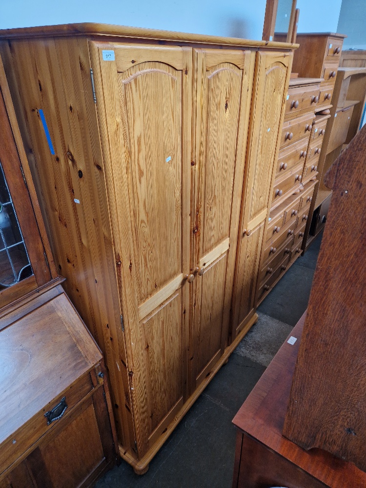 Various items of pine furniture; wardrobe, two chests of drawers, bedside cabinets and a mirror.