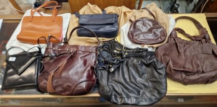 A mixed lot of leather handbags including Armani, DKNY, etc.
