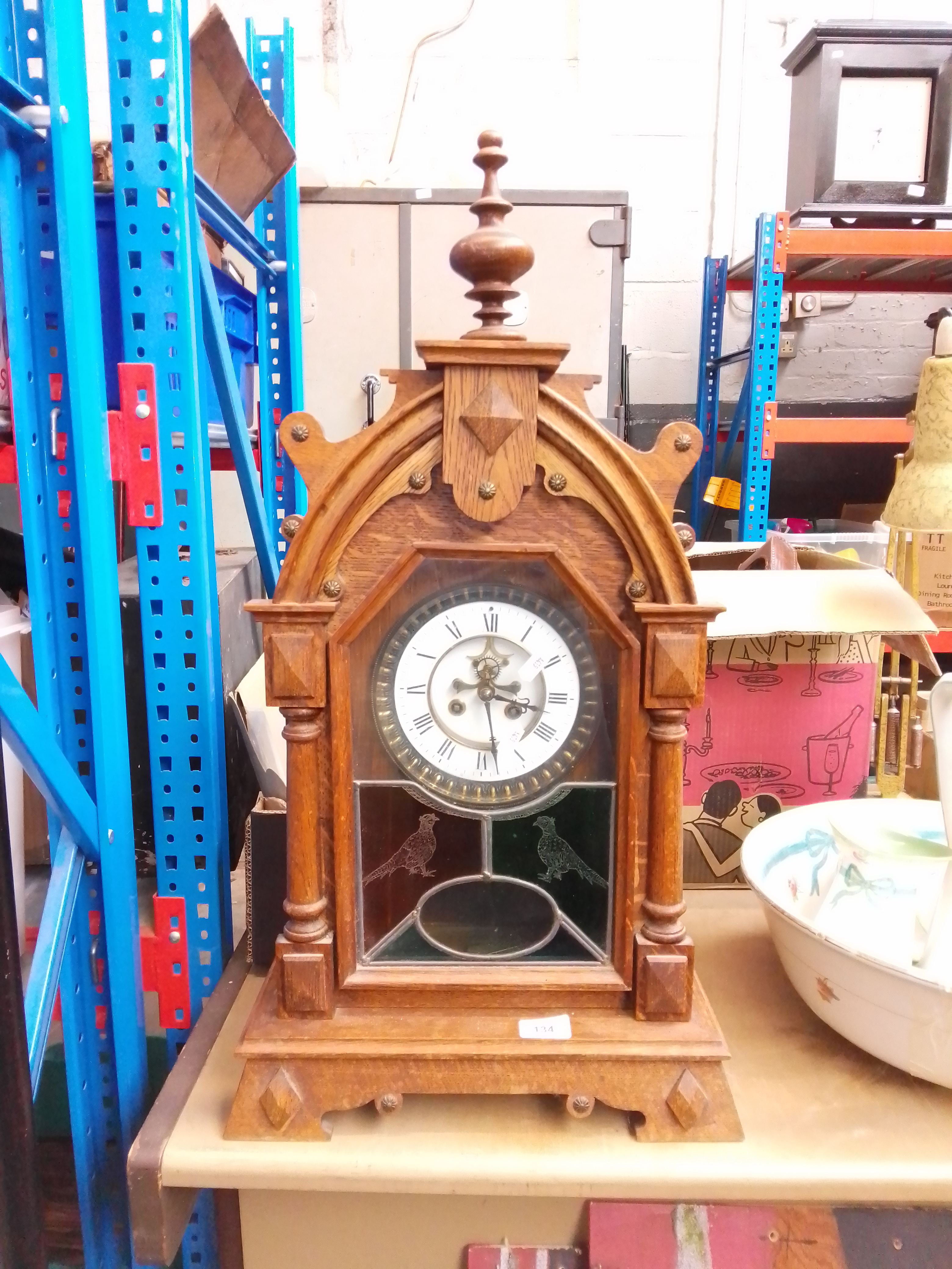 A Gothic style clock with wood frame, key and pendulum - as found