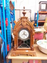 A Gothic style clock with wood frame, key and pendulum - as found