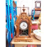 A Gothic style clock with wood frame, key and pendulum - as found