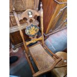 An inlaid walnut and cane seat folding chair, circa 1900.