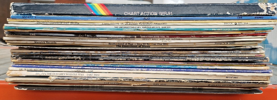 A box of vinyl LP records, mostly rock including Alice Cooper, Twisted Sister, Mott the Hoople,